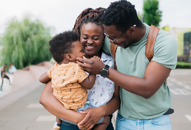 Family smiling at child